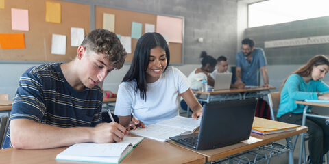 Teenager classmates doing exercise and working together in the Secondary School Classroom - Multi ethnic caucasian and Latin American students
