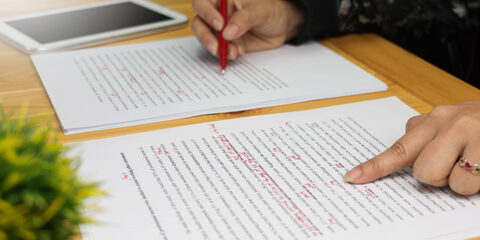hand working on paper for proofreading